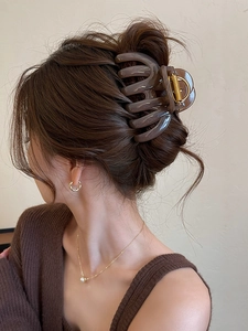 Deep brown translucent acrylic hair claw clip shown in a stylish updo on a model