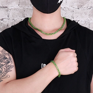 Close-up of green and silver stainless steel Byzantine chain necklace and bracelet set