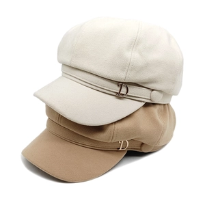 British newsboy caps in beige and khaki with decorative metal D buckle detail