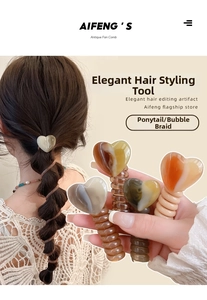 Detail of heart-shaped spiral hair ties in amber and beige for bubble braids