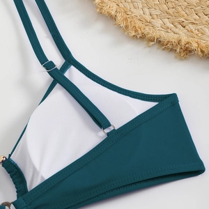 Detail of dark green bikini top with breathable honeycomb lining and adjustable straps