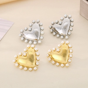 18K gold plated stainless steel heart earrings with white pearl border on beige background