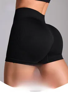 Detail of high-waisted black seamless yoga shorts with compression ribbing texture