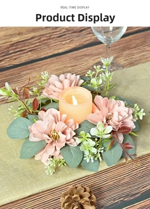 Pink dahlia candle ring with LED light on rustic dining table setting with pine cones