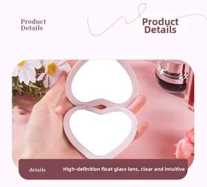 Close-up of pink heart-shaped folding makeup mirror showing high-definition dual mirrors