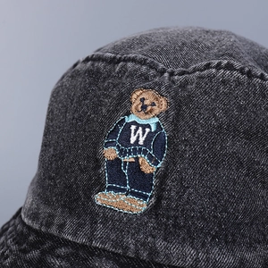 Distressed dark gray denim bucket hat featuring detailed bear embroidery with W sweater