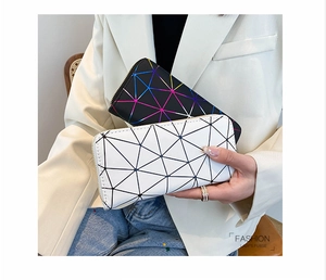 Detail showing fashion lady's purse with geometric triangle pattern and gold zipper