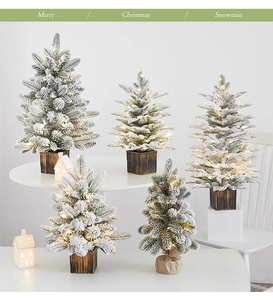 Mini tabletop Christmas tree with warm LED lights and rustic wooden base for holiday decor