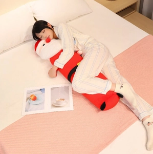 Detail of soft plush Santa Claus body pillow with red fabric and black belt detail
