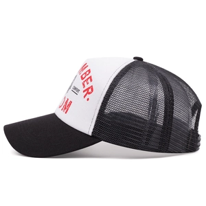Side view of two-tone mesh trucker hat with black brim and red printed text details