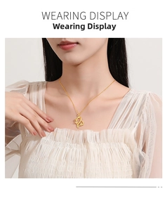Elegant gold heart and rose flower pendant necklace worn by model on white lace outfit