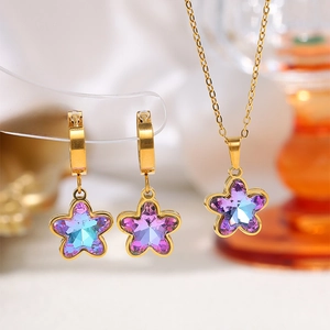 Macro view of butterfly heart set with purple and blue gradient crystals and gold finish