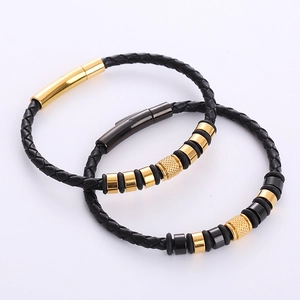 Men's woven leather bracelet set with gold and black magnetic clasps on white background