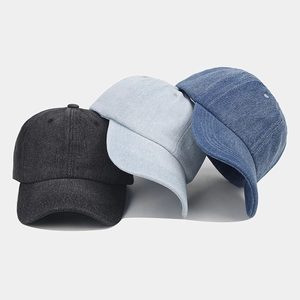 Detailed flat lay of denim baseball caps in black, light blue, and mid-blue wash