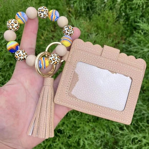Close-up of pink PU leather card holder with silicone leopard beads and tassel detail