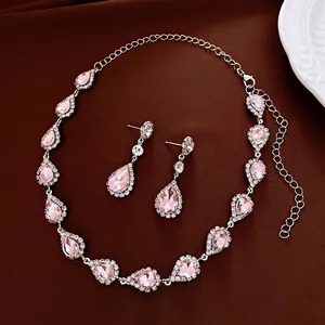 Elegant jewelry set with pink pear-shaped gemstones, silver necklace and matching earrings