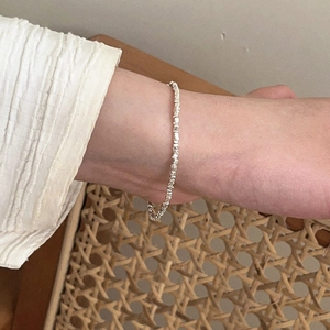 Close-up of s925 sterling silver crushed nugget bracelet worn on wrist with elegant texture
