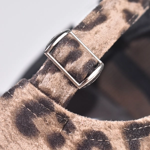 Detail view of the metal buckle and leopard print texture on this baseball cap