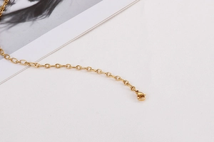 Detail of a minimalist gold O-chain necklace with a secure lobster clasp on white background