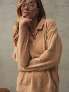 Close-up of camel fuzzy knit polo sweater with high-density plush texture and v-neckline