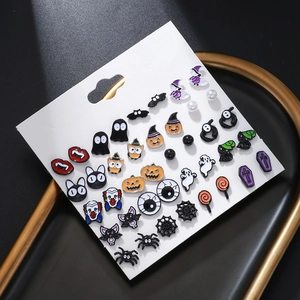 Halloween earring set featuring pumpkin, ghost, and spider charms on white display card