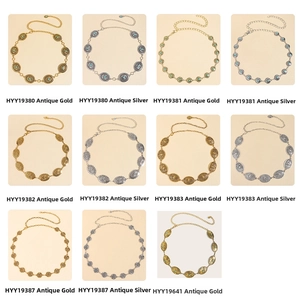 Detail showcasing variety of vintage metal waist chains in antique gold and silver finishes