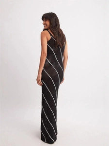 Elegant back view of black and white striped crochet maxi dress with hollow out details
