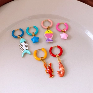 Detail of colorful enamel sea animal earrings set in gold stainless steel finish
