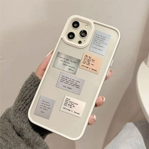 Close-up of vintage inspirational quote stickers on an off-white DIY phone case