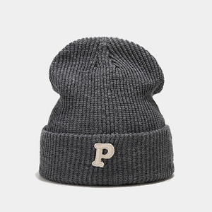 Detail of charcoal grey ribbed beanie featuring a 3D white embroidered P letter patch
