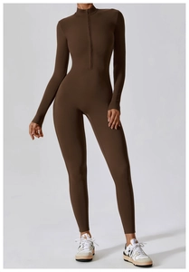 Detail of high-stretch yoga jumpsuit with standing collar and half-zipper in dark brown