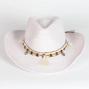 Detailed weave of white straw cowboy hat with shell tassels and boho metal charms