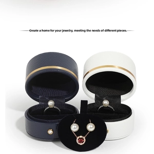 Close-up of PU leather jewelry boxes with gold trim and velvet pendant display stand