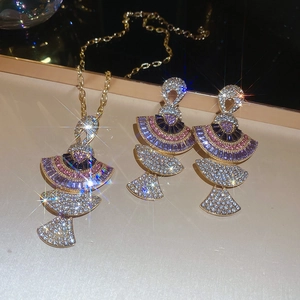 Detailed view of fan-shaped jewelry set featuring purple and pink crystal rhinestones