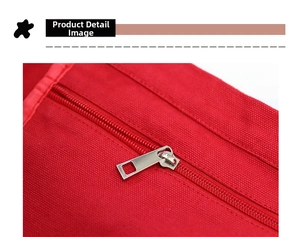 Detail of a silver metal zipper on red canvas fabric showing texture and durability