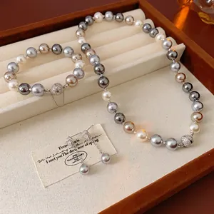 French style pearl jewelry set with necklace, bracelet and earrings in a beige tray