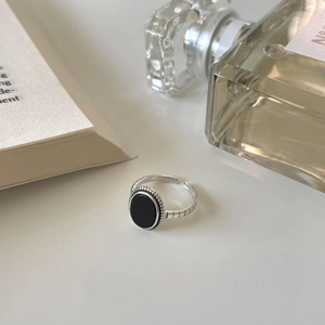 Detail of adjustable 925 silver ring with black onyx stone and vintage engraved patterns