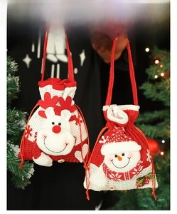 Detail of knitted Christmas drawstring gift bags featuring reindeer and snowman designs