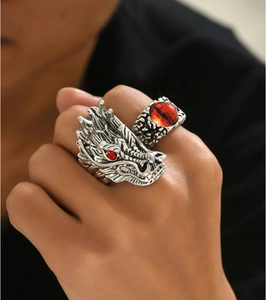 Close-up of retro silver dragon ring with red stones and evil eye design for men
