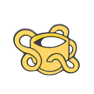 Detail of yellow enamel cartoon cup brooch pin with black outlines and smooth finish