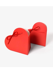 Detail of red heart-shaped gift boxes with satin ribbon bows for Valentine's Day