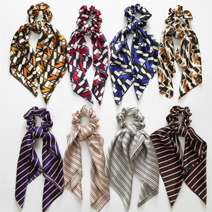 Set of eight satin ribbon scrunchies with geometric and striped patterns on white background