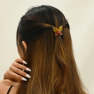 3.5cm butterfly hair clip with yellow and red gradient design on female model hair