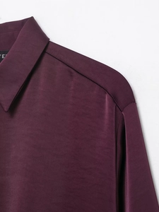Close-up of the smooth satin texture and neat shoulder stitching on a purple poplin shirt