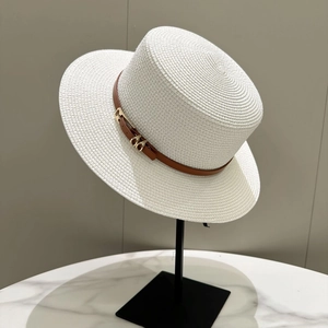Close-up of white boater straw hat with brown leather band and gold metal buckle