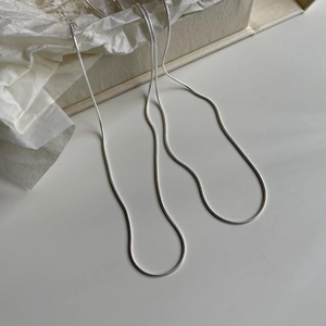 Detailed view of a sleek 925 sterling silver snake chain resting on soft white tissue