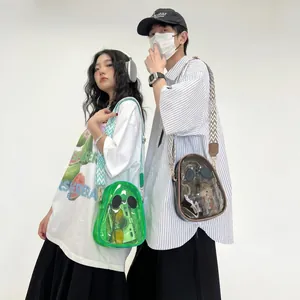 Detail of transparent PVC jelly crossbody bags with funny cartoon eyes and woven straps