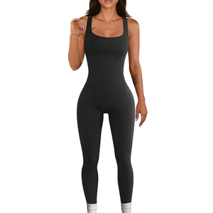 Detail of black ribbed knit jumpsuit showing the square neck and slim fit fabric texture