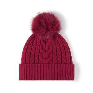 Women's burgundy cable knit beanie with fluffy pom-pom and warm fleece lining