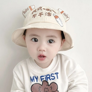 Detailed close-up of a beige baby sun hat with cute 3D ears and cartoon embroidery